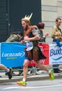 Happy Marathon runner in funny costume cheering by public. Charity money raise. London, UK