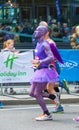Happy Marathon runner in funny costume cheering by public. Charity money raise. London, UK