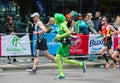 Happy Marathon runner in funny costume cheering by public. Charity money raise. London, UK