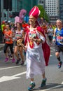 Happy Marathon runner in funny costume cheering by public. Charity money raise. London, UK