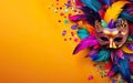 Happy Mardi Gras poster. Banner template with Venetian masquerade mask, confetti and feathers on warm yellow background Royalty Free Stock Photo