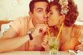 Happy marriage concept. Portrait of a beautiful married couple of hipsters in trendy clothing drinking mojito and kissing in