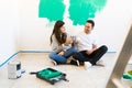 Happy married couple with coffee cups while renovating their home Royalty Free Stock Photo