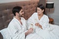 Happy married couple drinking champagne in bed Royalty Free Stock Photo