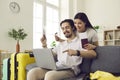 Happy married couple at home using a laptop to pay for tickets and book a hotel room online. Royalty Free Stock Photo