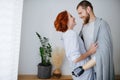 Happy married couple in love at home, standing close, looking at each other