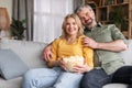 Happy Married Middle Aged Couple Watching Tv And Eating Popcorn At Home Royalty Free Stock Photo