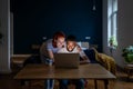 Happy young married multiracial couple using laptop together at home, planning summer vacation Royalty Free Stock Photo