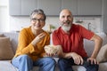 Happy Married Senior Couple Watching Tv And Eating Popcorn At Home Royalty Free Stock Photo