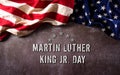 Happy Martin Luther King Day anniversary concept. American flag against dark stone background Royalty Free Stock Photo