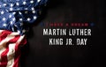 Happy Martin Luther King Day concept. American flag againt black wooden background