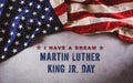 Happy Martin Luther King Day concept. American flag againt dark stone background