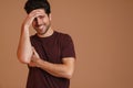 Happy masculine young man smiling and covering his face Royalty Free Stock Photo