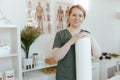 happy massage therapist woman in massage cabinet