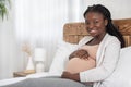 Happy Maternity Time. Portrait Of Smiling Black Pregnant Lady Resting On Bed Royalty Free Stock Photo