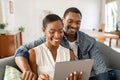 Happy mature african american couple using digital tablet at home Royalty Free Stock Photo