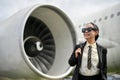 A happy mature Asian businesswoman boards a plane for her business trip Royalty Free Stock Photo