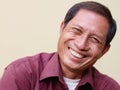 Happy mature Asian man smiling at camera Royalty Free Stock Photo