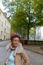 Happy mature beautiful tourist woman thinking at the park outdoors Royalty Free Stock Photo