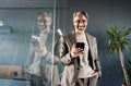 Happy mature business man entrepreneur standing in office using mobile phone. Royalty Free Stock Photo