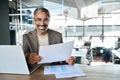 Happy mature business man manager with documents and laptop in office. Portrait. Royalty Free Stock Photo