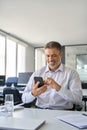 Happy mature business man manager using mobile phone at work in office. Royalty Free Stock Photo