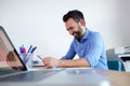 Happy mature business man sitting at his desk and using digital tablet Royalty Free Stock Photo