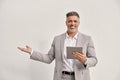 Happy middle aged business man using digital tablet isolated showing aside. Royalty Free Stock Photo