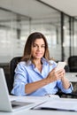 Happy mature business woman executive using phone working in office. Portrait Royalty Free Stock Photo