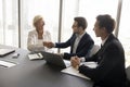 Happy mature business woman giving handshake to colleague man Royalty Free Stock Photo