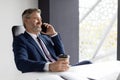 Happy Mature Businessman Having Work Break, Talking On Cellphone And Drinking Coffee Royalty Free Stock Photo