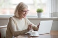 Happy mature businesswoman excited reading good news looking at