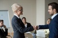 Happy mature businesswoman leader handshaking greeting welcoming new partner Royalty Free Stock Photo