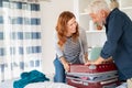 Happy mature couple closing suitcase Royalty Free Stock Photo