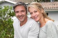 Happy mature couple in front of their new home Royalty Free Stock Photo