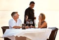 Happy mature couple having dinner at the beach. Shot of a mature couple enjoying a romantic dinner on the beach. Royalty Free Stock Photo
