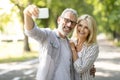 Happy Mature Couple Having Fun While Taking Selfie On Smartphone Outdoors Royalty Free Stock Photo