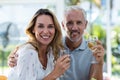 Happy mature couple holding wineglass