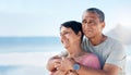 Happy, mature couple and hug outdoor at beach with a smile, care and happiness together. Man and woman thinking of Royalty Free Stock Photo