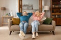 Happy Mature Couple Leaning On Couch Relaxing At Cozy Home Royalty Free Stock Photo