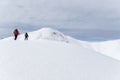 Senior couple is snowshoe hiking in alpine snow winter mountains. Allgau, Bavaria, Germany. Royalty Free Stock Photo