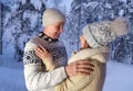 Happy mature couple, man 60 years old and woman 55 years old are have fun, hugging in winter forest, early evening in park among Royalty Free Stock Photo