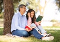 Happy mature couple reading books together while relaxing in city park Royalty Free Stock Photo