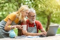 Happy Mature Couple Relaxing With Laptop At Home Terrace Outdoors Royalty Free Stock Photo