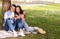 Happy Mature Couple Relaxing In Park Together And Using Smartphone Royalty Free Stock Photo