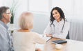 Happy mature couple shaking hands with their nurse Royalty Free Stock Photo