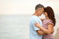 Happy mature couple spending time  on sea beach. Space for text Royalty Free Stock Photo