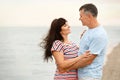 Happy mature couple spending time  on sea beach. Space for text Royalty Free Stock Photo