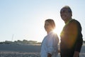 Happy mature couple standing on beach on summer day and smiling Royalty Free Stock Photo