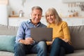 Happy Mature Couple Using Laptop Browsing Internet Together At Home Royalty Free Stock Photo